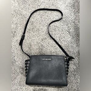 Michael Kors Black crossbody purse w/ silver studded sides. Slightly used.